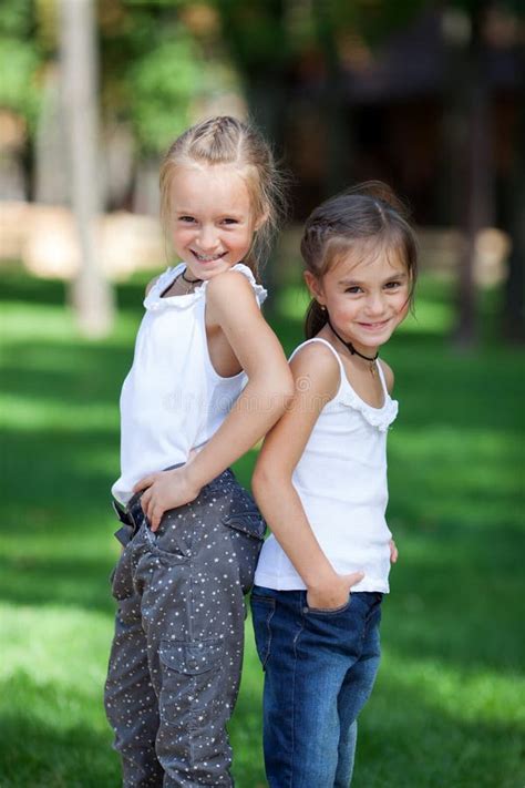 Wonderful Happy Girls Standing On The Lawn Stock Photo Image Of