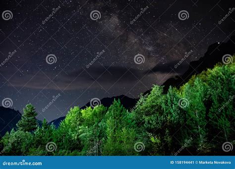 Milky Way With Falling Star Above Mountain Peaks In National Park