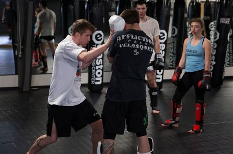 Coach Cory Demonstrating A Combination Kickboxing Sporty Coach