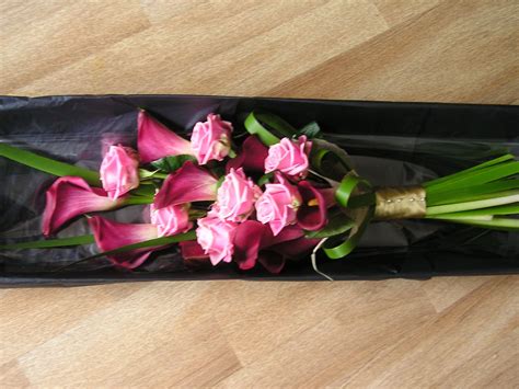 Over The Arm Style Bouquet Using Typha Grass With Roses And Cala