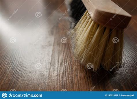 Dirty Wooden Broom With Yellow And Black Bristles Stand On Floor