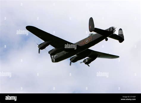 Ww2 British Raf Avro Lancaster Bomber Plane On A Pass Over An Airfield