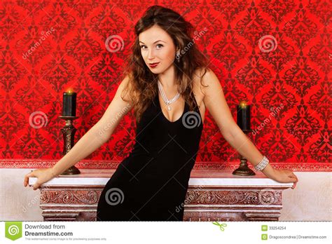Sensual Girl In Red Vintage Room With Two Burning Candles On Fir Stock