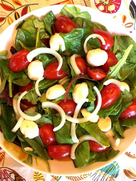 Arrange tomatoes, mozzarella, and basil leaves in an alternating pattern on a large serving platter. Fresh Tomato Mozzarella Salad Recipe - Melanie Cooks