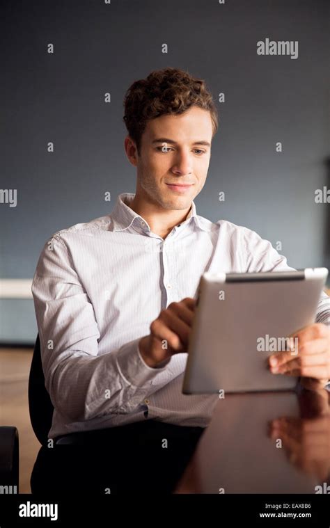 Businessman Using Digital Tablet In Office Stock Photo Alamy