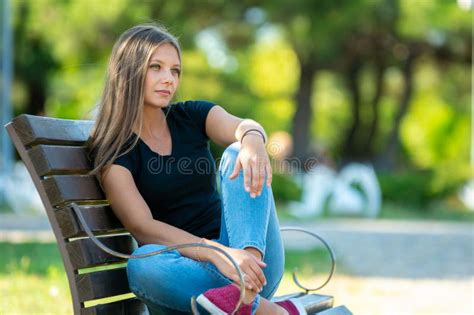 Girl Sitting On A Bench In The Park Close Up Stock Photo Image Of