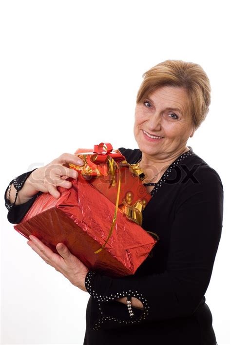 Birthday gifts for a 70 years old woman; Beautiful older woman with a gift on a ... | Stock Photo ...