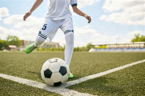 Boy Kicking Ball On Football Field - Stock Photos | Motion Array