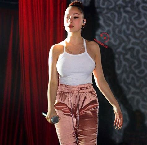 A Woman In Pink Pants And White Tank Top Walking Down A Stage With A