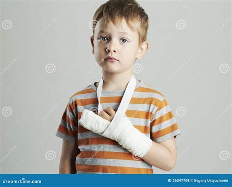 Sad Child With A Broken Arm In The Home Environment The Cast On The
