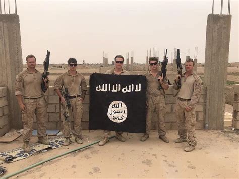 2nd Bn7th Marines Hold Isis Flag Captured During Recent Deployment To