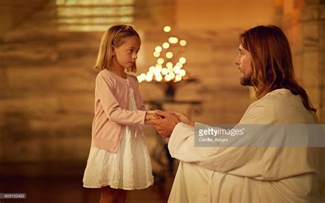 Cropped Shot Of A Little Girl Holding Hands With Jesus While Standing