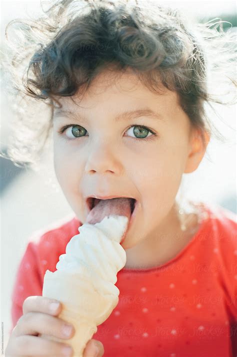 Portrait Of A Cute Little Girl Eating An Ice Cream Cone Del