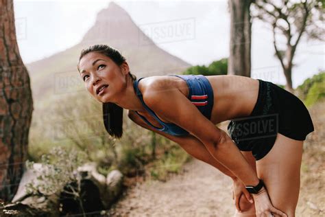 Young Asian Woman In Sportswear Standing On Mountain Trail With Her