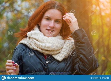 Portrait Of A Red Haired Smiling Girl In A Jacket And Scarf