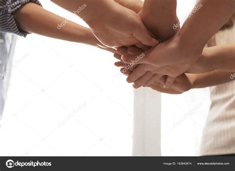 Young People Putting Hands Together As Symbol Of Unity Stock Photo By