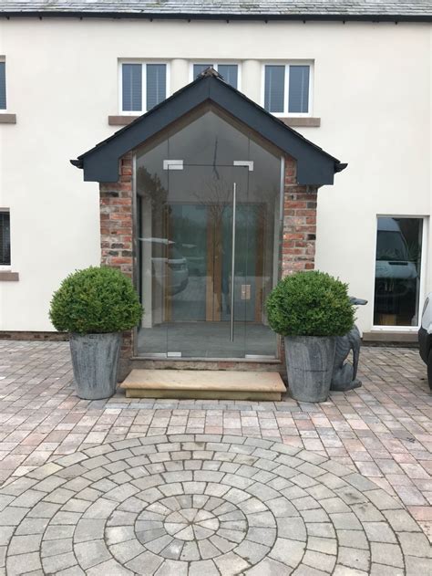 Even a canopy will offer a surprising amount of shelter while you fumble for your keys. frameless glass porches uk - Google Search in 2020 | Glass ...