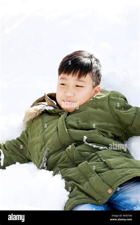 Boy Lay Down On The Snow And Enjoy Snow In The Winter Stock Photo Alamy