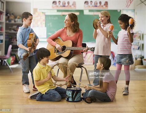 Teacher Teaching Music Lesson To Children Stock Photo | Getty Images