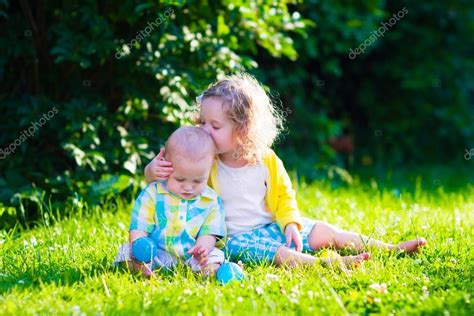 Happy Children Playing In The Garden With Toy Balls Stock Photo By