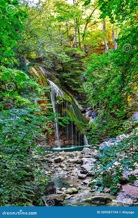 Beautiful Waterfall Among The Forest In The Mountains Stock Photo