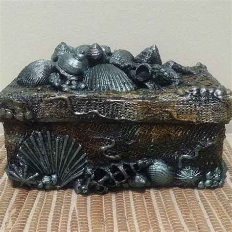 A Decorative Box With Shells And Seashells On It