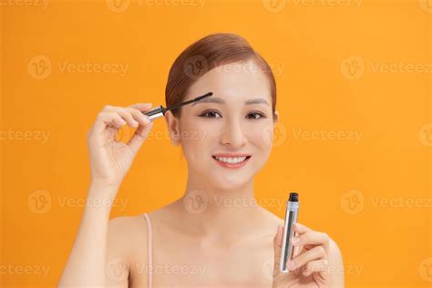 Beautiful Young Woman With Eyelash Extensions Applying Mascara On
