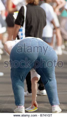 Obesity Fat Lady Bending Over Wearing Blue Denim Jeans Rear View Stock