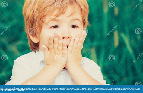 Child Expressing Surprise With His Hands In His Face Smiling Amazed Or