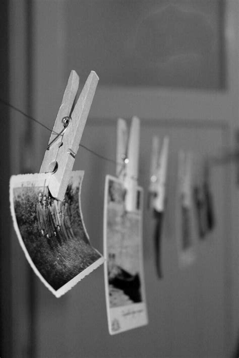 Clothes Pins Hanging On A Line With Pictures Hung To Dry In Front Of