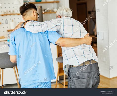 Doctor Nurse Caregiver Helping Senior Man Stock Photo 1990308647