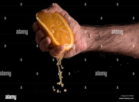 Male Hand Squeezing An Orange Stock Photo Alamy