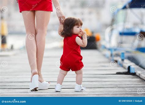 la madre enseña a la pequeña hija a caminar solamente foto de archivo imagen de ella tenencia