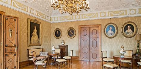 An Ornately Decorated Room With Antique Furniture And Paintings On The