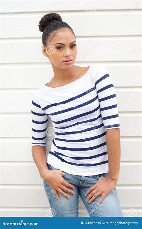 Female Fashion Model Standing Outdoors Against White Background Stock