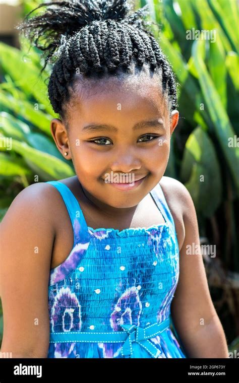 Close Up Portrait Of Cute African Girl In Blue Dress And Braided