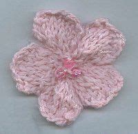 Knit 7 stitches, *one flower, knit 4 stitches*. knit your own cute flower..I used this pattern and it was ...