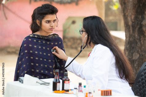 Indian Female Doctor Checking Young Adult Girl Patient Heartbeat With