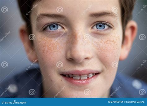 Close Up Portrait Of A Teenage Boy With Blue Eyes And A Blue Shirt A