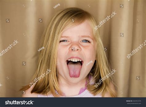 Стоковая фотография 343761575 Young Girl Sticking Her Tongue Out Shutterstock