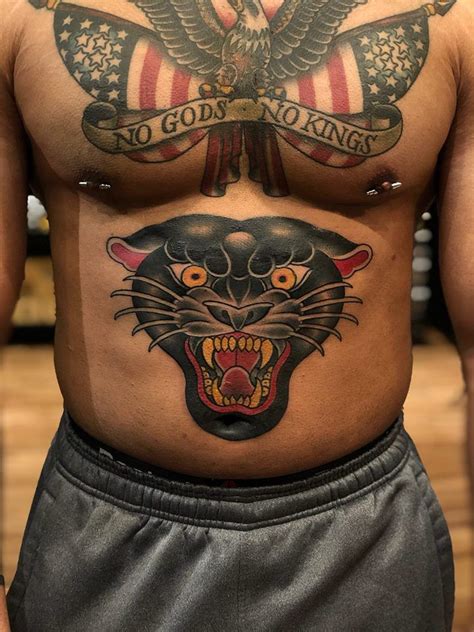 A Man With Tattoos On His Stomach Has An Eagle And Tiger Tattoo On His