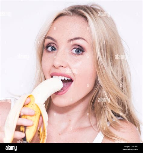 Pretty Blonde Woman Eating A Banana Stock Photo Alamy