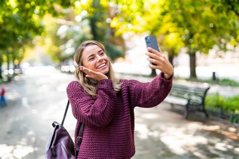 Young Woman Take Selfie From Hands With Phone On Summer City Street