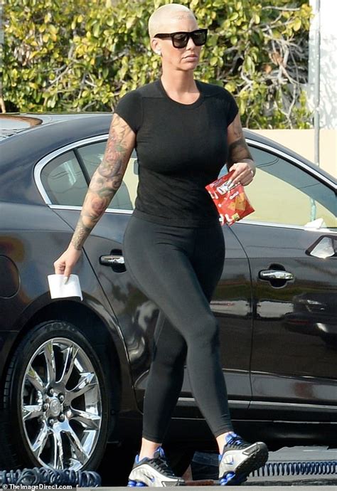 amber rose shows off her famous curves in skintight black ensemble daily mail online