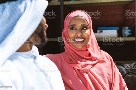 Happy Middle Eastern Couple Wearing Traditional Arab Clothing At Home