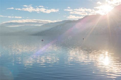 Sunlight Shining Over Mountains And Skaha Lake Just Before Sunset In
