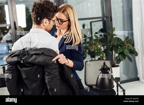 Young Businesswoman Undressing Colleague In Office Flirting And Office