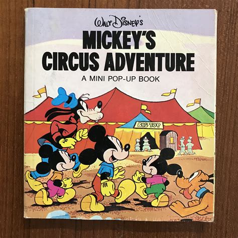 The Mickey Mouses Circus Adventure Book Is On A Wooden Table With