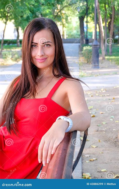 beautiful fashionable girl sitting on park bench brunette posing sexy stock image image of