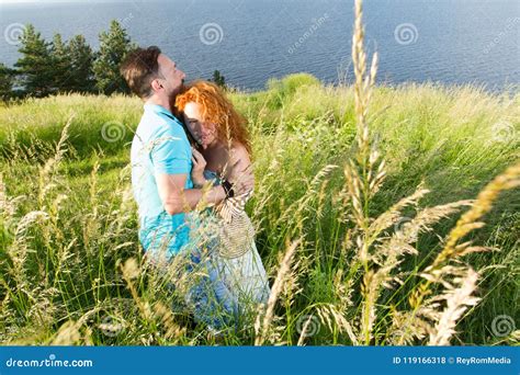 Young Couple In Love Hugging In Big Green Grass Couple In Love